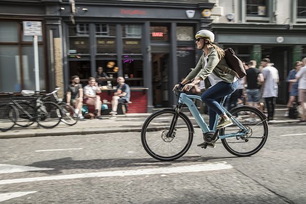 A person riding an electric bike on a city street